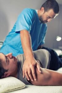 Chiropractor adjusting a male patients lower back at back to mind